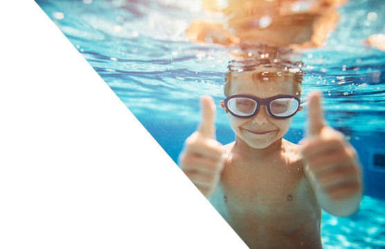 young-boy-in-goggles-swimming-underwater-in-blue-pool-thumbs-up-horizontal-7360x4912-image-file-670950038